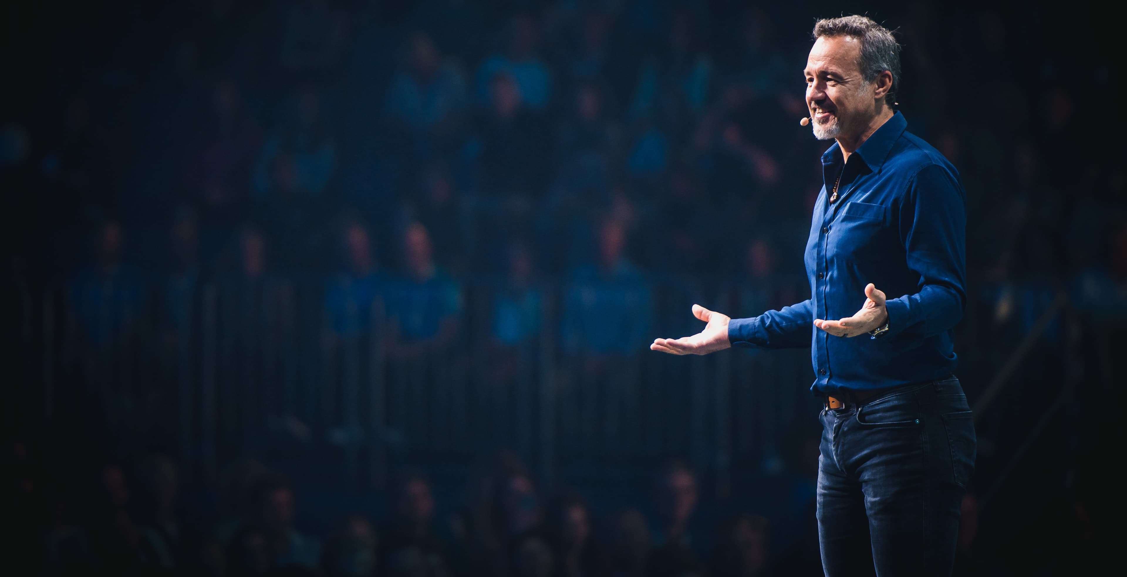 Eric Edmeades speaking on stage